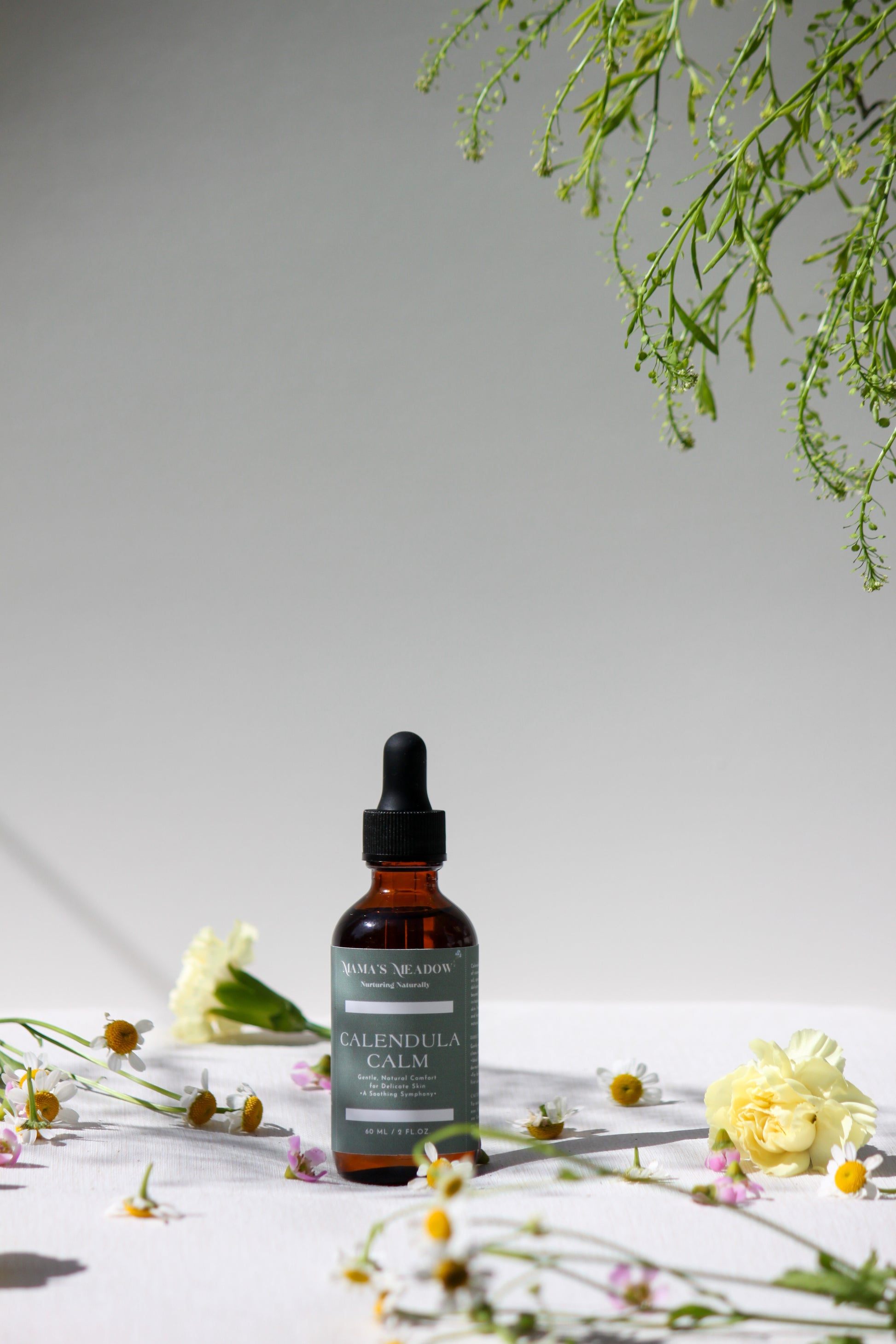 A gentle, all-purpose skin oil in a glass bottle, infused with coconut oil, jojoba oil, and calendula oil to hydrate and soothe sensitive skin, perfect for the whole family.