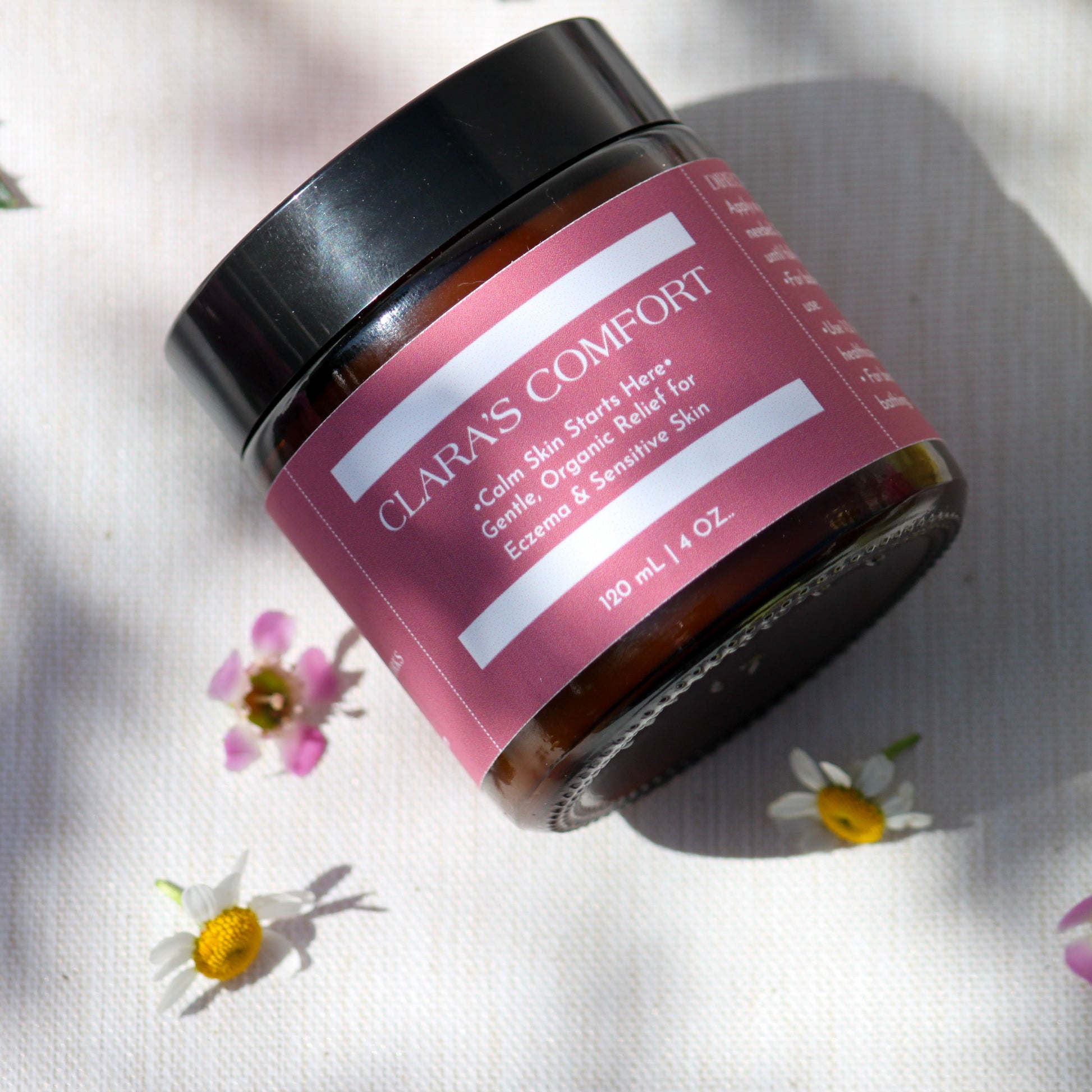 A 4oz jar of Clara’s Comfort, a rich, organic balm handcrafted with shea butter, calendula oil, and colloidal oatmeal to soothe eczema, dry skin, and irritation for babies and beyond.