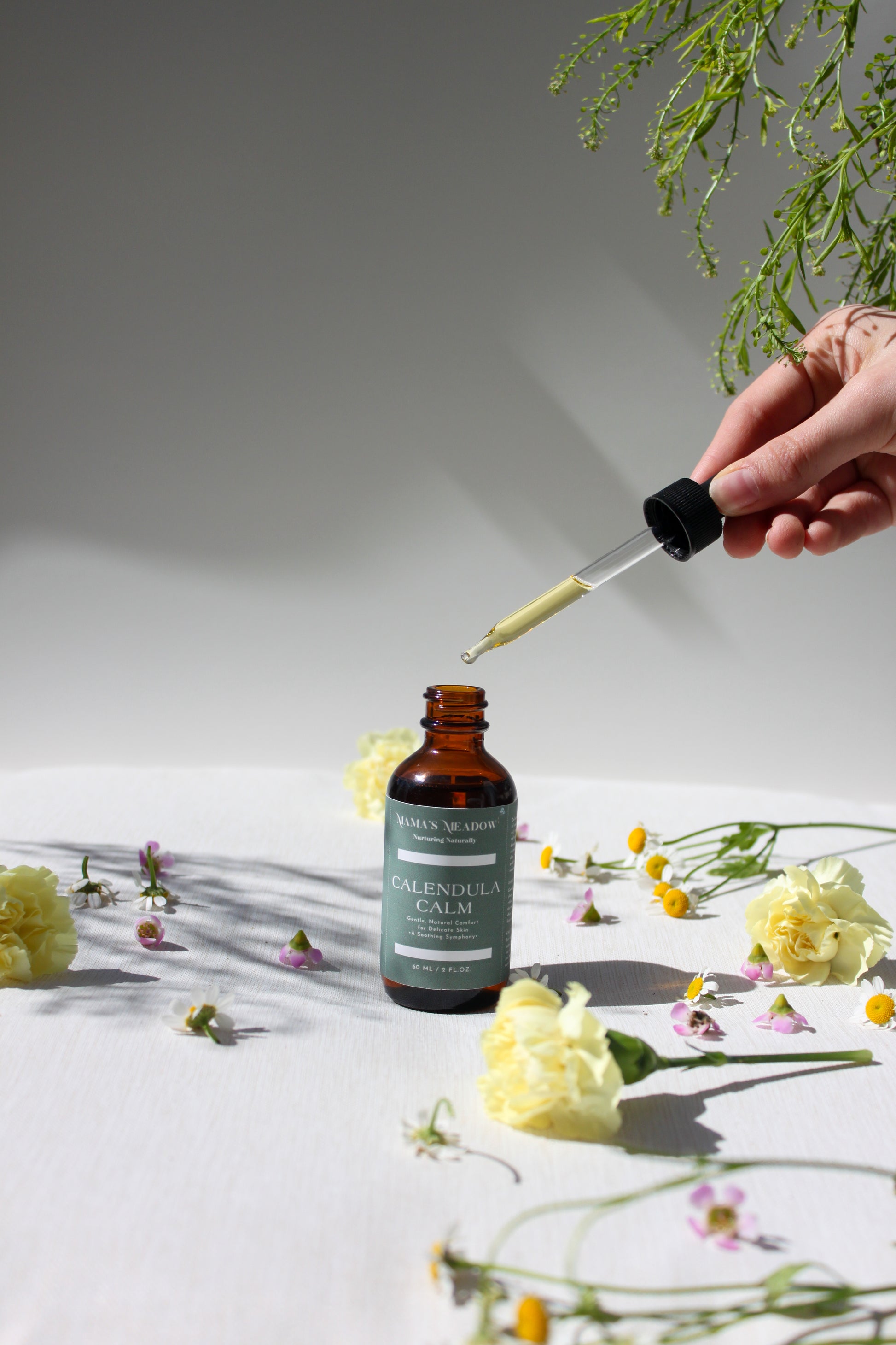 A gentle, all-purpose skin oil in a glass bottle, infused with coconut oil, jojoba oil, and calendula oil to hydrate and soothe sensitive skin, perfect for the whole family.