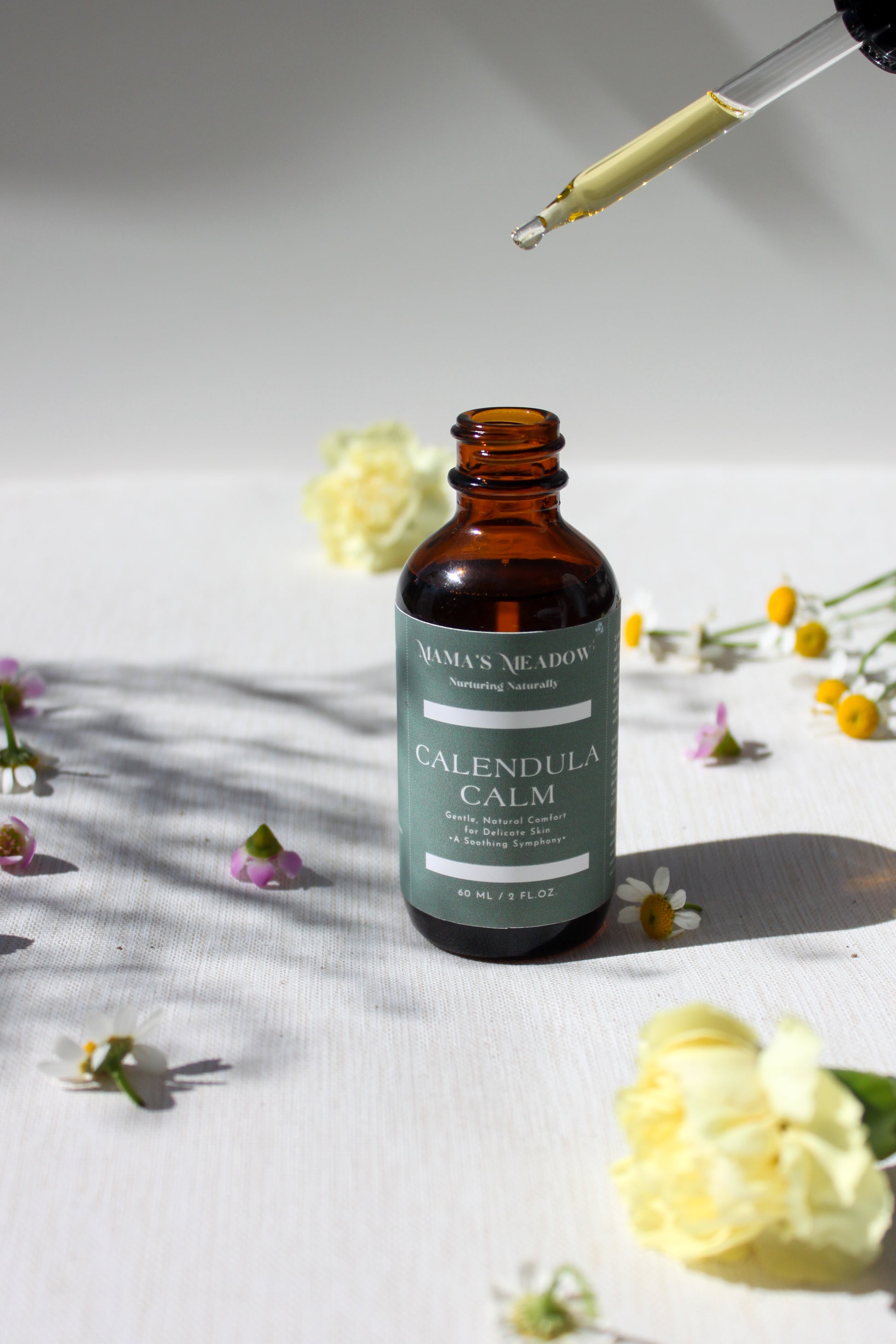 A gentle, all-purpose skin oil in a glass bottle, infused with coconut oil, jojoba oil, and calendula oil to hydrate and soothe sensitive skin, perfect for the whole family.