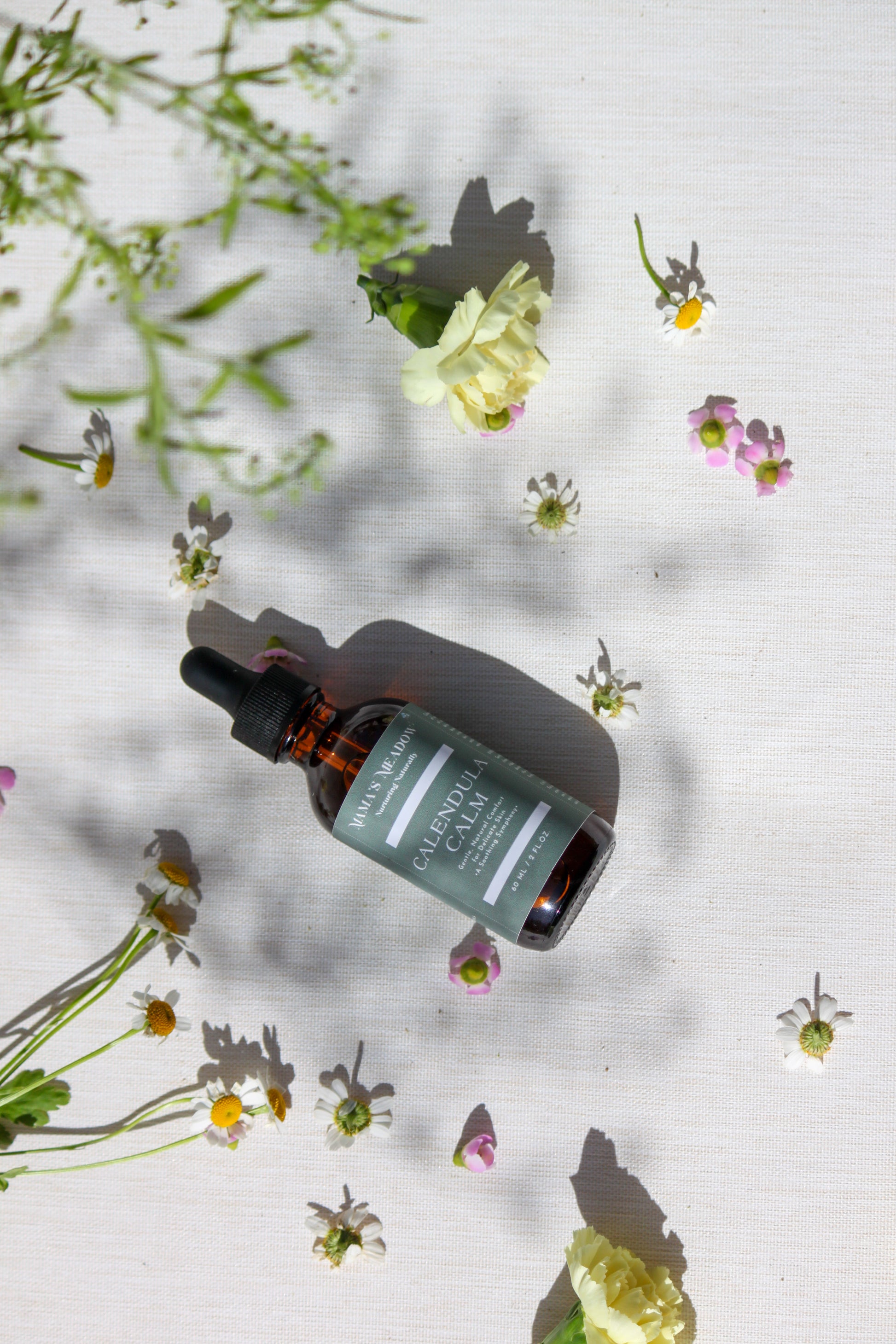 A gentle, all-purpose skin oil in a glass bottle, infused with coconut oil, jojoba oil, and calendula oil to hydrate and soothe sensitive skin, perfect for the whole family.