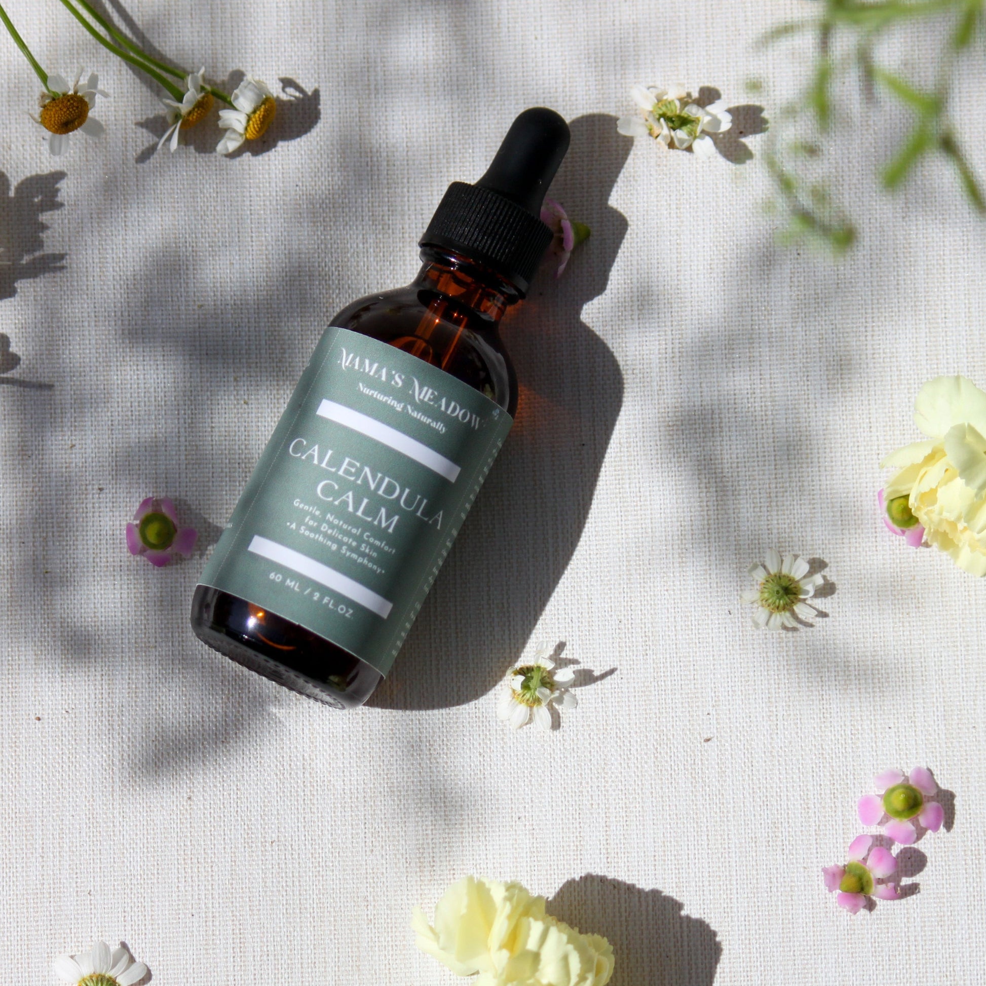 A gentle, all-purpose skin oil in a glass bottle, infused with coconut oil, jojoba oil, and calendula oil to hydrate and soothe sensitive skin, perfect for the whole family.