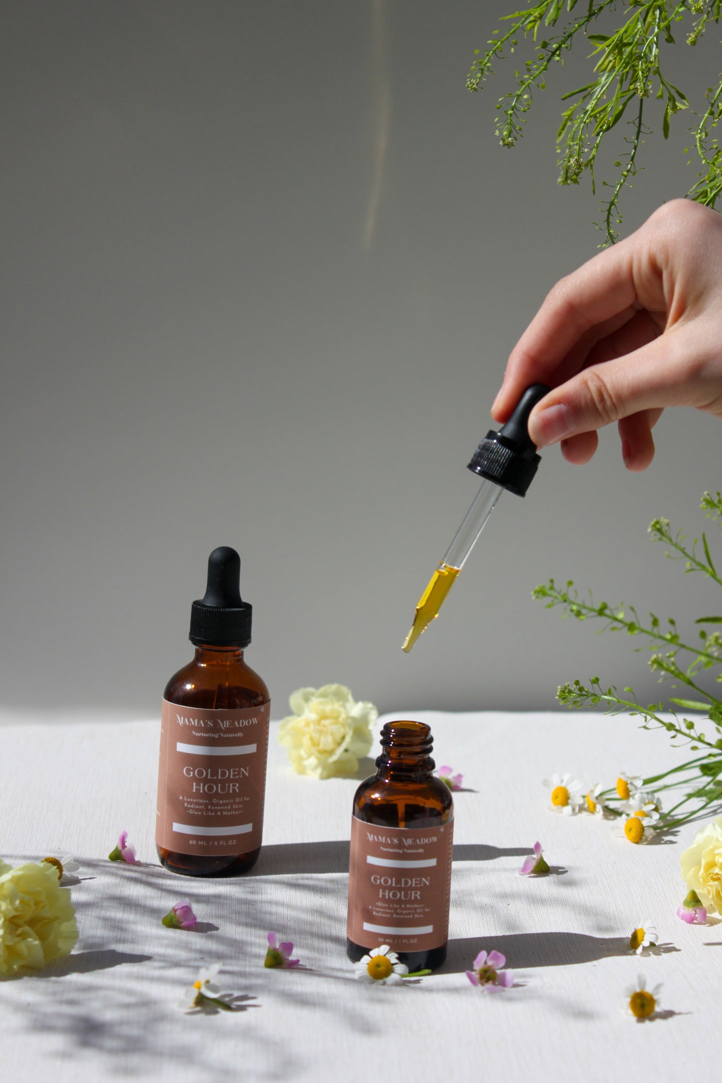 A luxurious evening facial oil in a glass dropper bottle, made with black seed oil, rosehip oil, and frankincense essential oil to nourish, restore radiance, and reduce fine lines for busy mothers.