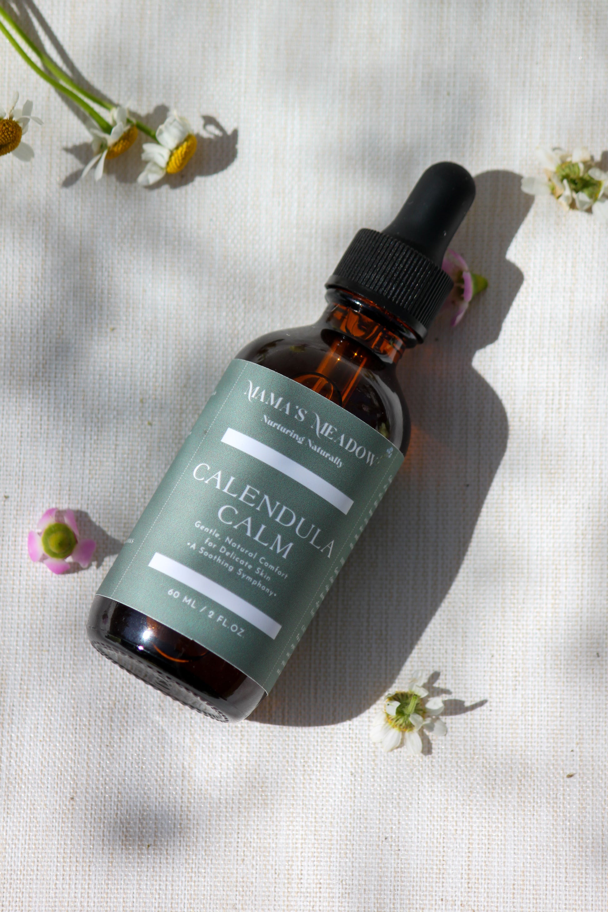 A gentle, all-purpose skin oil in a glass bottle, infused with coconut oil, jojoba oil, and calendula oil to hydrate and soothe sensitive skin, perfect for the whole family.