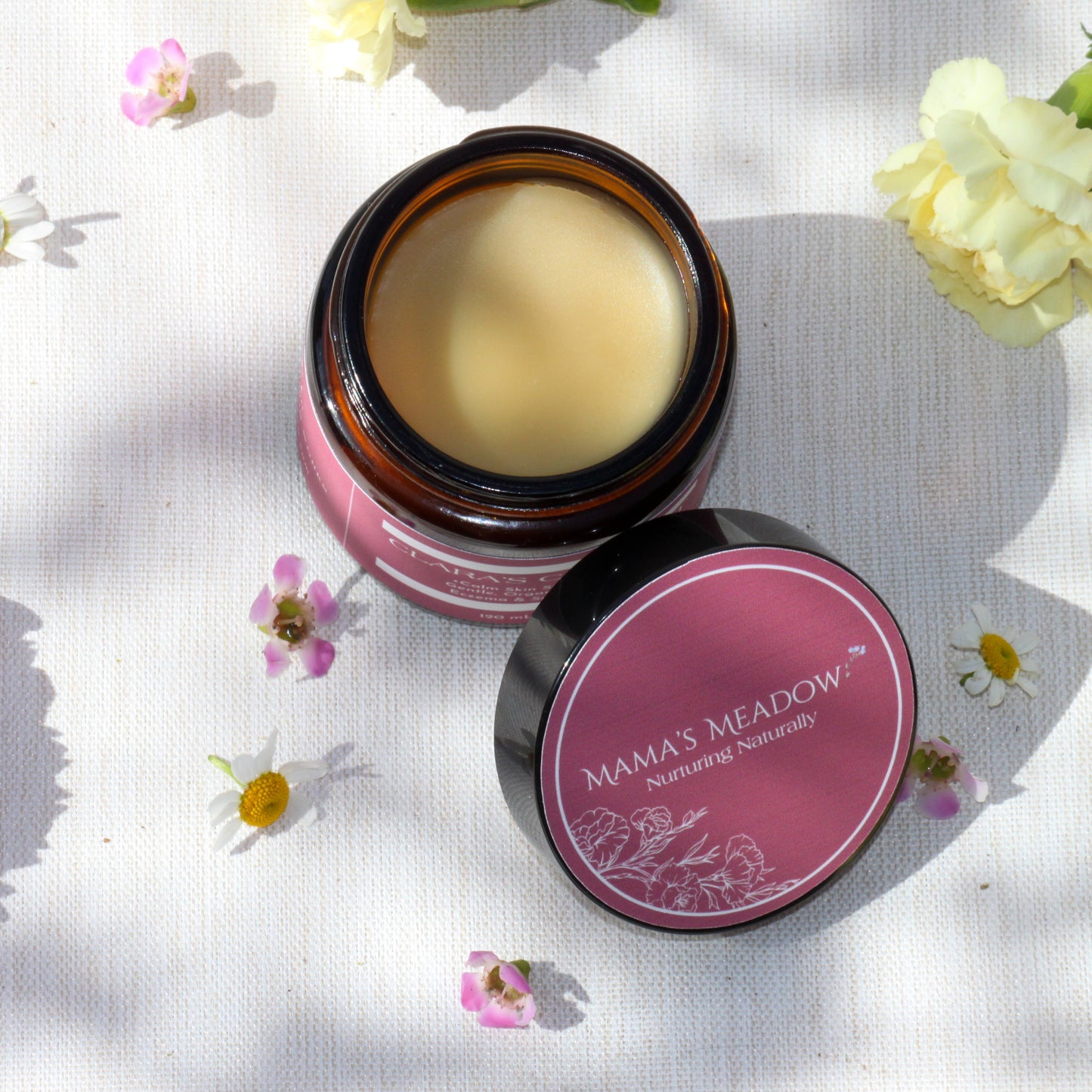 A 4oz jar of Clara’s Comfort, a rich, organic balm handcrafted with shea butter, calendula oil, and colloidal oatmeal to soothe eczema, dry skin, and irritation for babies and beyond.