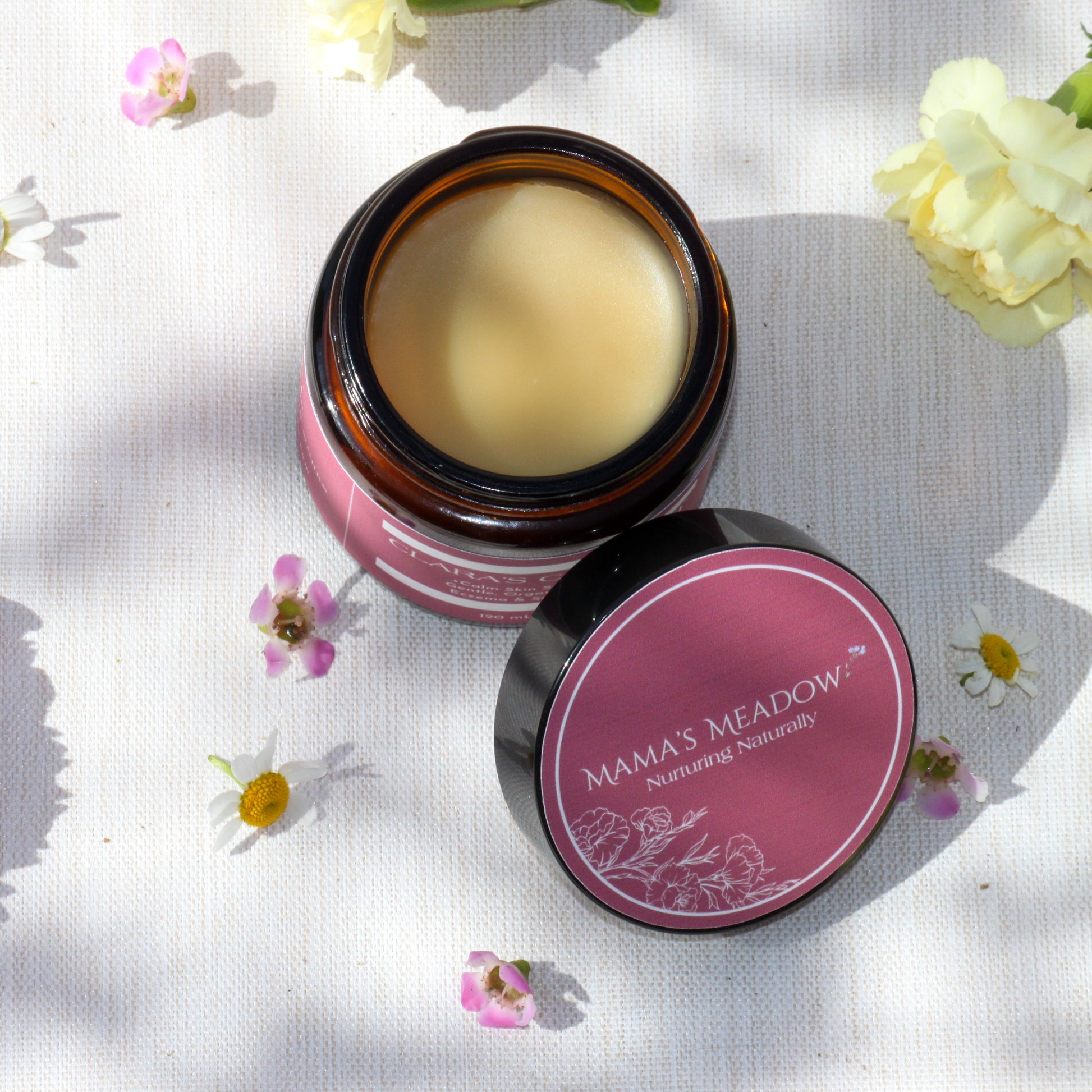 A 4oz jar of Clara’s Comfort, a rich, organic balm handcrafted with shea butter, calendula oil, and colloidal oatmeal to soothe eczema, dry skin, and irritation for babies and beyond.