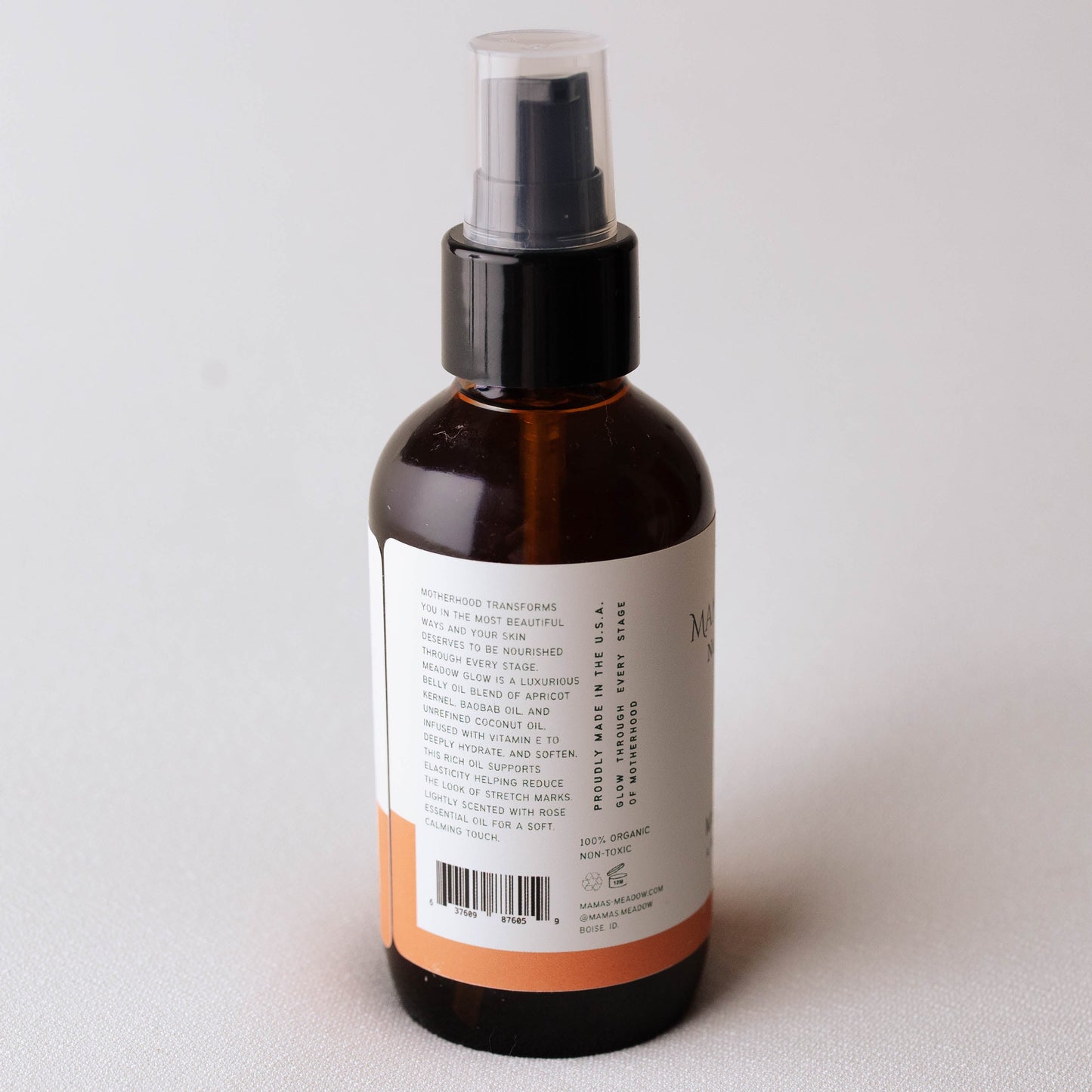 Brown  Mama's Meadow spray bottle with a label on a light gray background