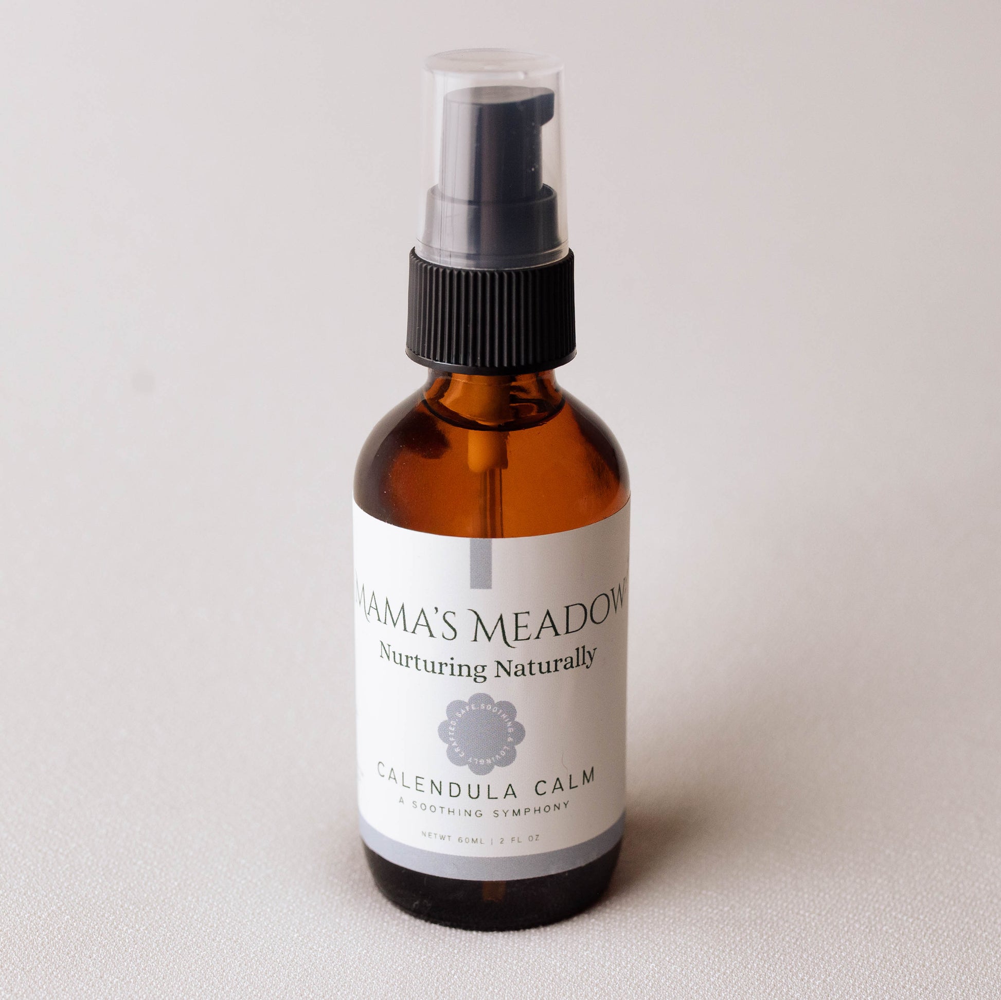 Amber glass bottle with a label on a light gray background