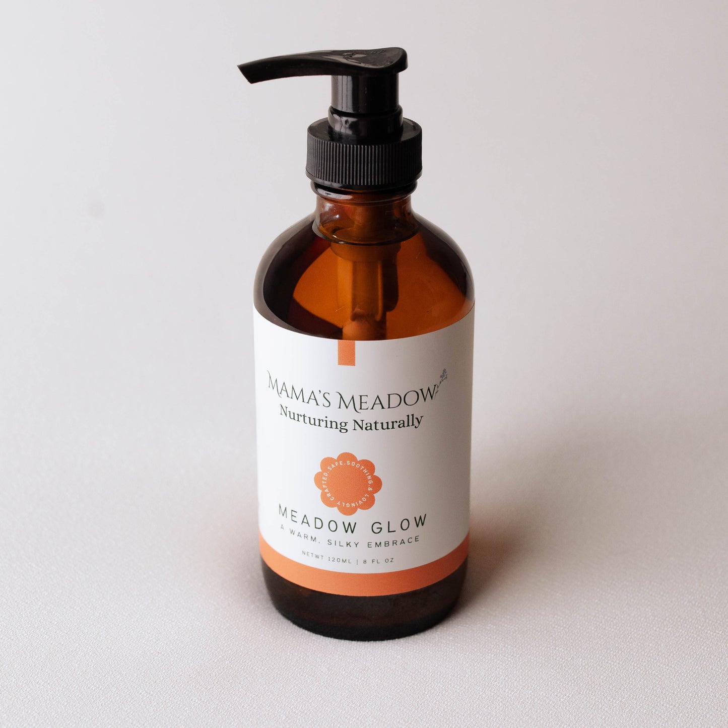 Brown bottle with pump and 'Mama's Meadow' label on a light gray background