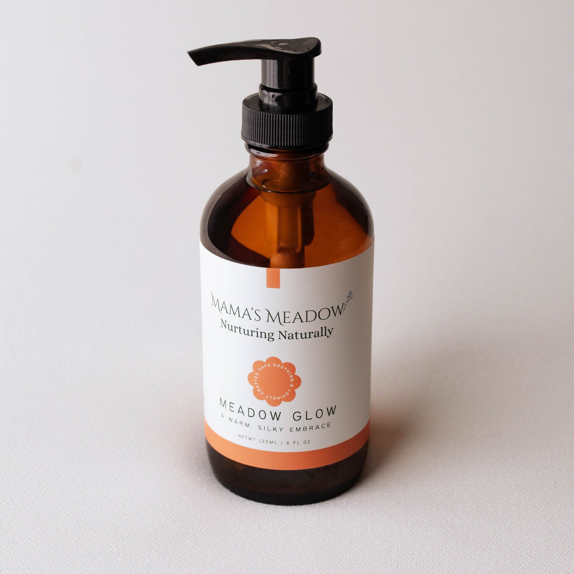 Brown bottle with pump and 'Mama's Meadow' label on a light gray background