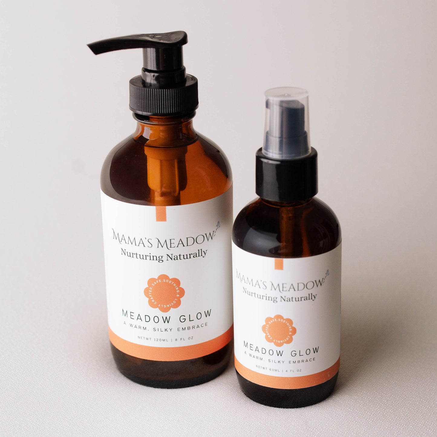 Two bottles of 'Mama's Meadow' skincare products on a light background