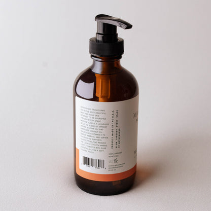 Brown bottle with pump dispenser on a light gray background