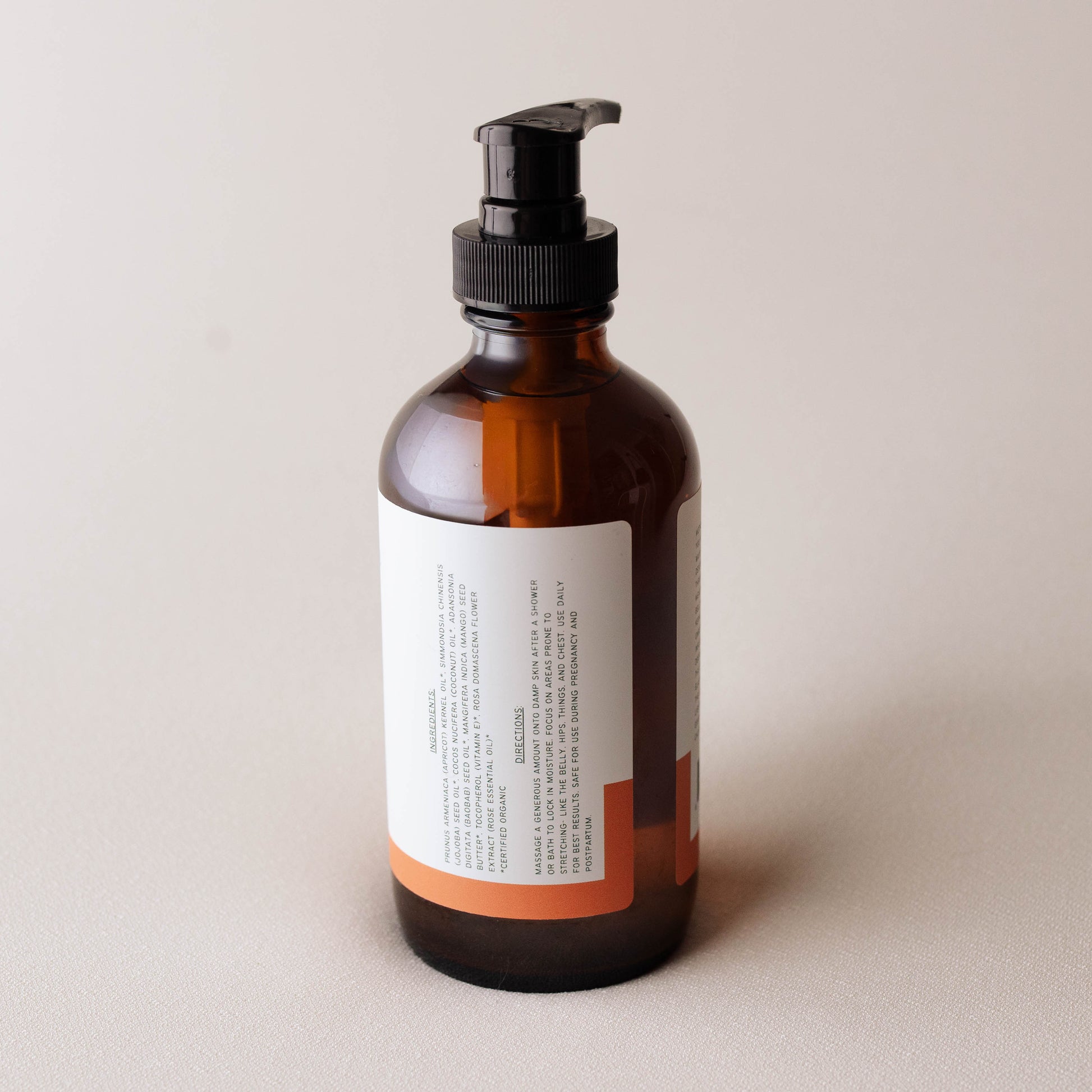 Brown bottle with pump dispenser on a light beige background